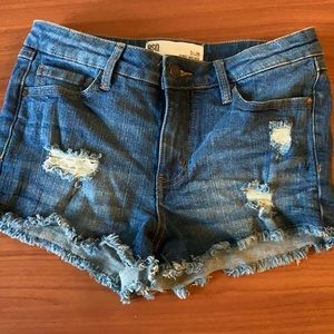 RSQ mid rise short shorts with fringe.